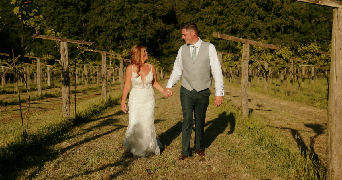 Carli and Neil celebrating their wedding at Old Luxters Barn