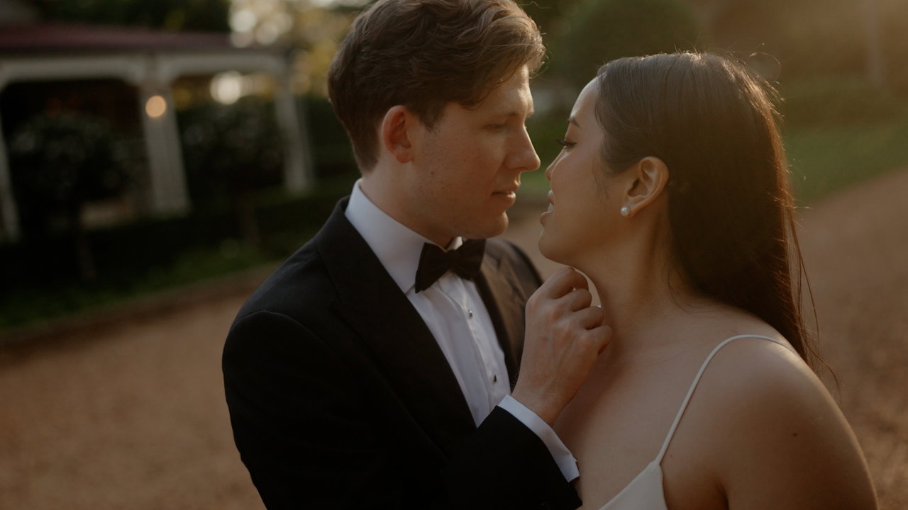Tina and Alex face to face on a gravel drive in the late afternoon light